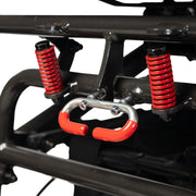 Close-up of the Travel Buggy DASH 3 folding frame locking mechanism with red springs and handle