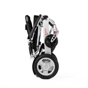 Travel Buggy City 2 Plus power chair, silver, folded and standing upright