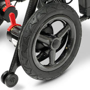 Close-up of the Phoenix electric wheelchair carbon fiber rear wheel and frame